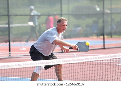 A Man Hits A Pickleball