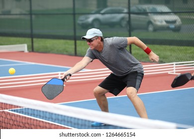 A Man Hits A Pickleball