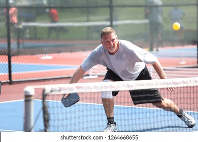 A Man Hits A Pickleball