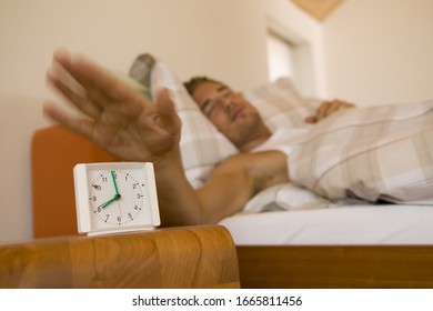 Man Hitting Snooze On His Alarm