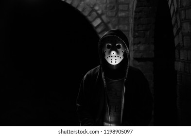 man in hockey mask at night. black and white photo for halloween