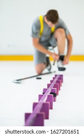 man with hockey stick and puck on ice
