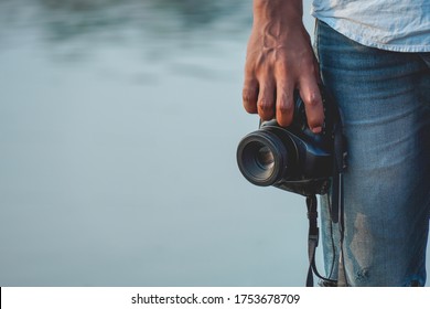 Man hodling DSLR camera in hand          