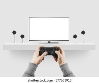 Man Hold Gamepad In Hands In Front Of Blank Tv Screen Mock Up Playing Game. Clear Monitor Mockup With Gamer First Person. Video Gaiming Console Screen Display. Gamer Play Game Pad On Tv Screen.