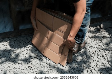 A man hold recycle paper box on terrace home. Stacking brown cardboard box, eco friendly packaging made of recyclable raw materials, Home recycle eco zero waste concept - Powered by Shutterstock