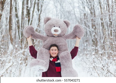 Man hold two big teddy bears soft toy as a present to his girlfriend for birthday party in the winter