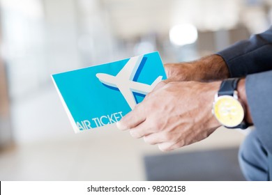 Man Holding Air Ticket In Airport