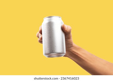 Man holding aluminum can on yellow background