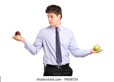 A Man Holding An Apple And Slice Of Cake Trying To Decide Which One To Eat Isolated On White Background