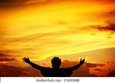 Man holding arms up in praise