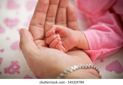 Man Holding A Baby Hand, Extreme Closeup 