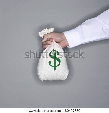 man holding bag of money on grey background 