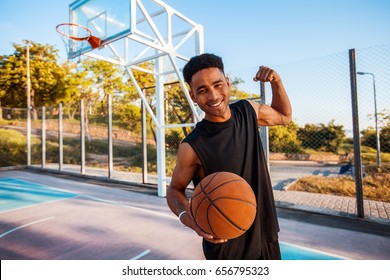 Man Is Holding A Basket Ball And Laughing,street Ball,sport Competitions,afro,outdoor Portrait,sport Games,handsome Black Man,pretty,man Holding Ball,sportsman,black Sport Shorts,sports Shoes