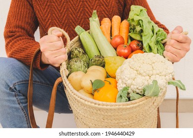 Man holding a basket full of organic veggies. Natural product concept. - Shutterstock ID 1946440429