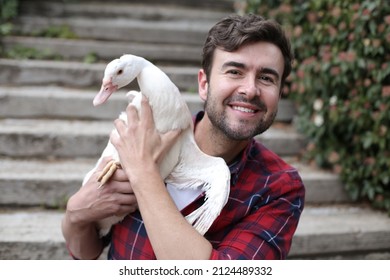 Man holding a beautiful white duck