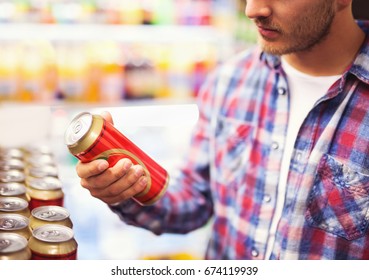 Man Holding Beer Can In A Liquor Store, Choosing Beer