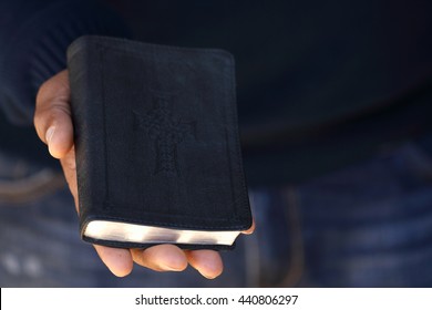 Man Holding The Bible