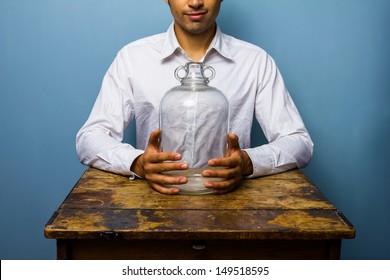 Man Holding Big Empty Glass Jar