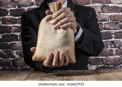 Man holding a big sack of money