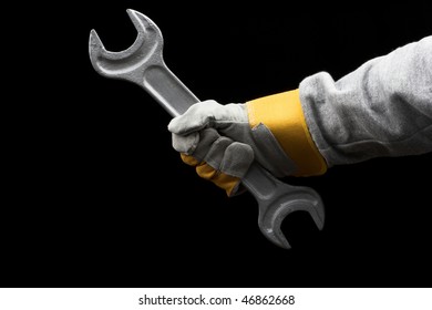 Man Holding A Big Wrench Over Black