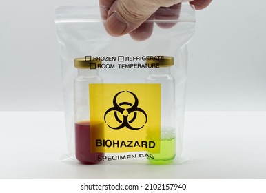 Man holding a Biohazard Specimen Bag in his hand with two test tubes inside.