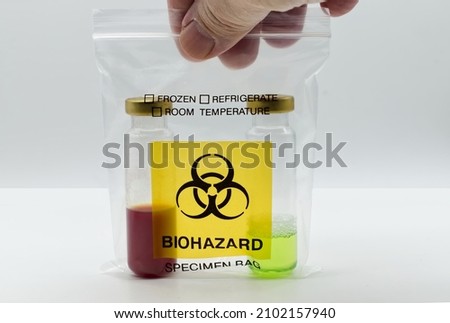 Man holding a Biohazard Specimen Bag in his hand with two test tubes inside.