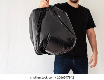 Man Holding Black Garbage Bag