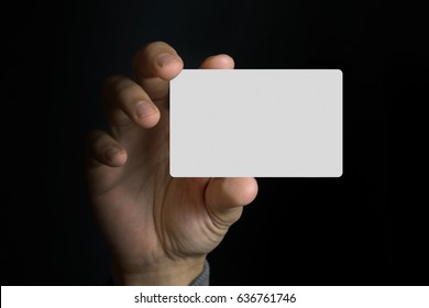 A Man Holding Blank Card With Dark Background