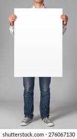 Man holding a blank poster
