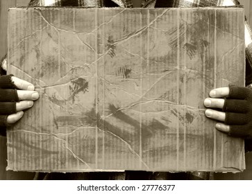 Man Holding Blank Worn Out Cardboard Sign