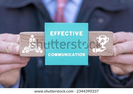 Man holding blocks with icons sees inscription: EFFECTIVE COMMUNICATION. Effective cooperation business concept. Partnership, teamwork. Colleagues assemble solutions together as effective job.