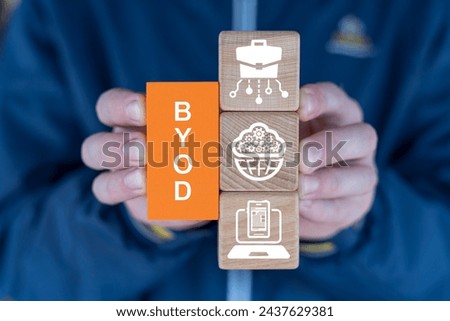 Man holding blocks sees abbreviation: BYOD. BYOD Bring Your Own Device or Distance Remote Learning Concept.
