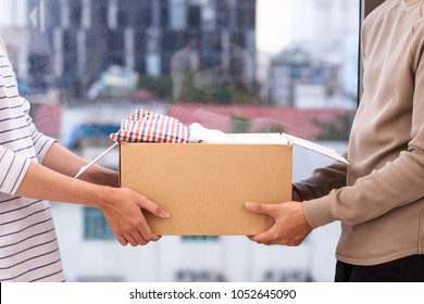 Man holding a book and clothes donate box. Donation concept. - Shutterstock ID 1052645090