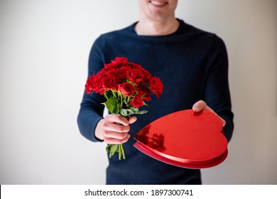 Man Holding A Bouquet of Flowers and Box Of Chocolates - Powered by Shutterstock