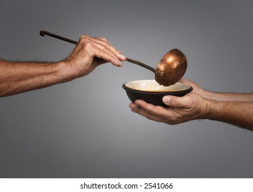 Man Holding A Bowl In Both Hands, Receiving A Serving Of Soup From Another Man Holding A Soup Ladle