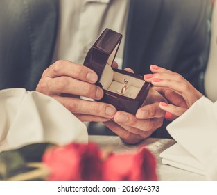 Man Holding Box With Ring Making Propose To His Girlfriend