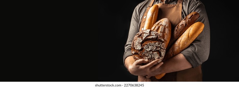 Man holding breas in his hands. Different types of bread. bakery products on a dark background. Long banner format. - Powered by Shutterstock