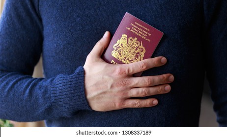 man holding british, european union passports. Devon, United Kingdom, January, 2019