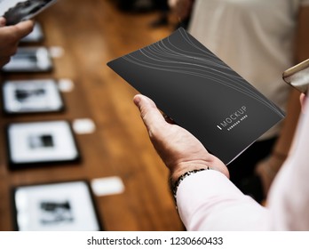 Man Holding A Brochure Mockup In An Art Gallery