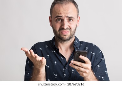 Man Holding A Broken Phone With Funny Expression.