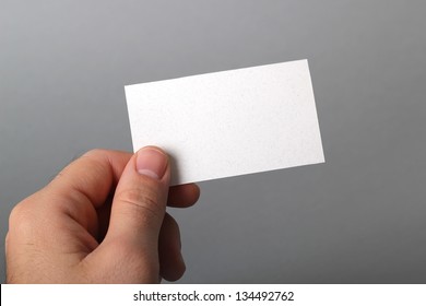 A Man Holding A Business Card