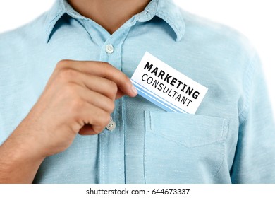 Man Holding Business Card In Hand, Closeup. Marketing Consultant Concept