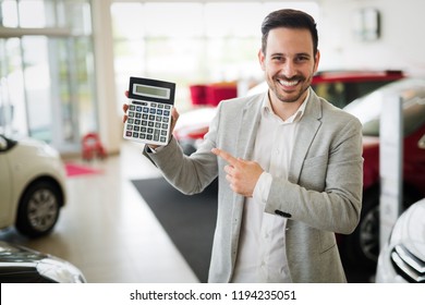 Man Holding A Calculator In The Car Showroom, Good Price