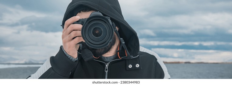 man holding camera on lake background
 - Powered by Shutterstock