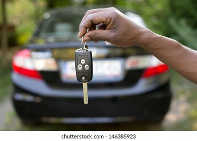 Man Holding Car Keys