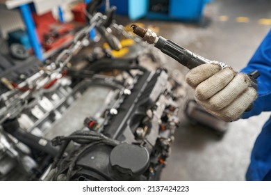 Man Holding Car Part In His Hands