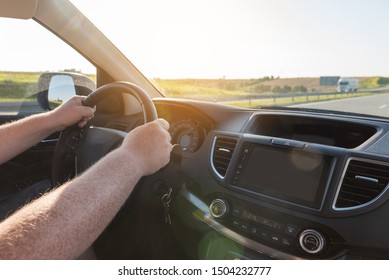Man holding car steering wheel. Concept of safe driving.