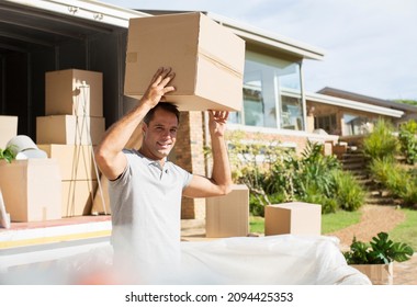 Man Holding Cardboard Box Overhead Near Moving Van In Driveway