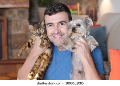 Man Holding Cat And Dog 