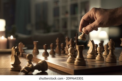 Man Holding A Chess Piece And Playing Alone At Home, Hand Close Up